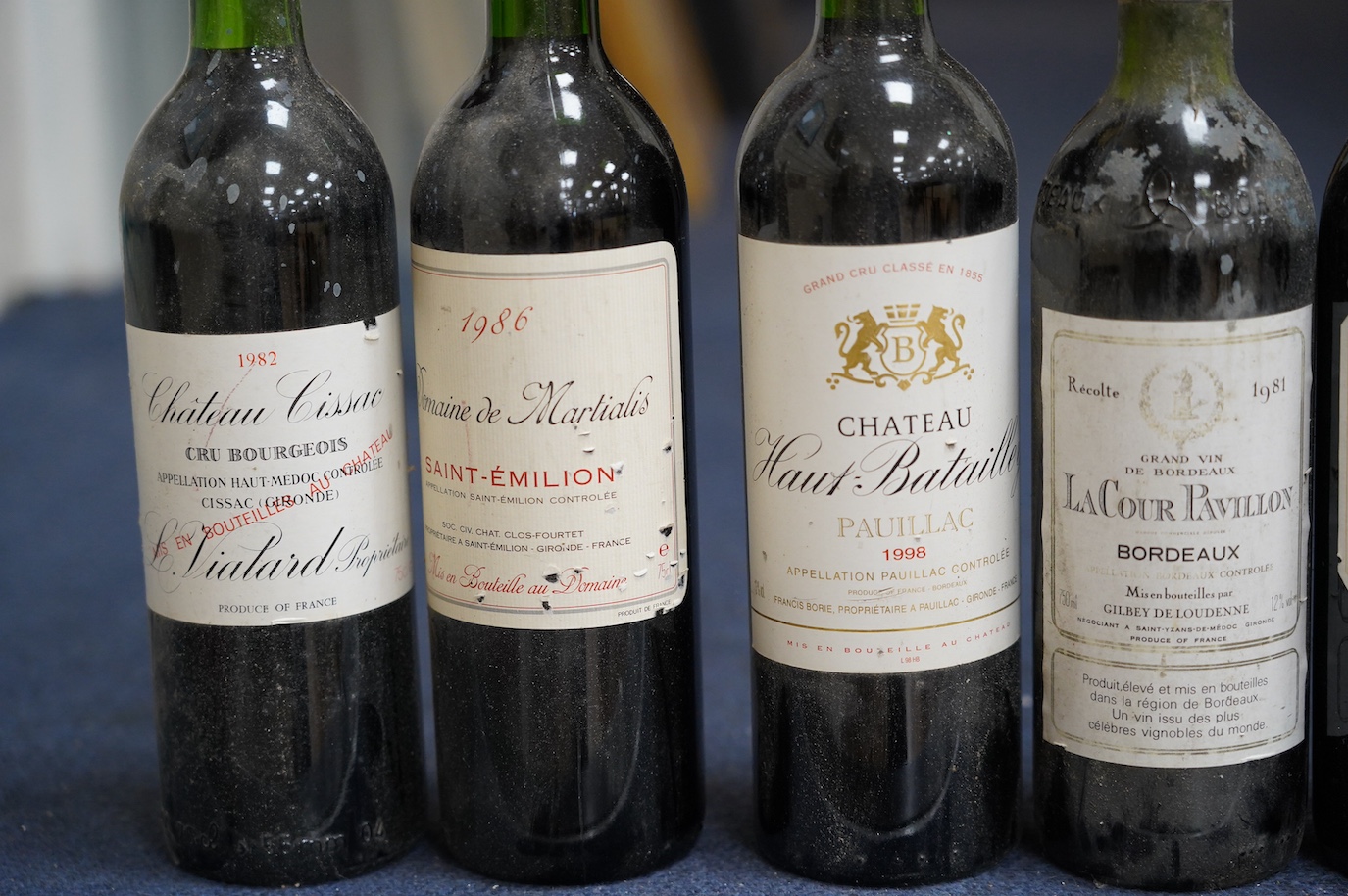 Eleven bottles of wine: Chateau Moulin Hargue 2003 x1, Chateaux Cissac 1982x2, Chateau la Coer Pavillion 1981 x2, Chateaux de barbe 1976 x1, Chateaux Haut Batailly 1998 x1, Premier Cotes de Bordeaux NV x1, Domain de Mart